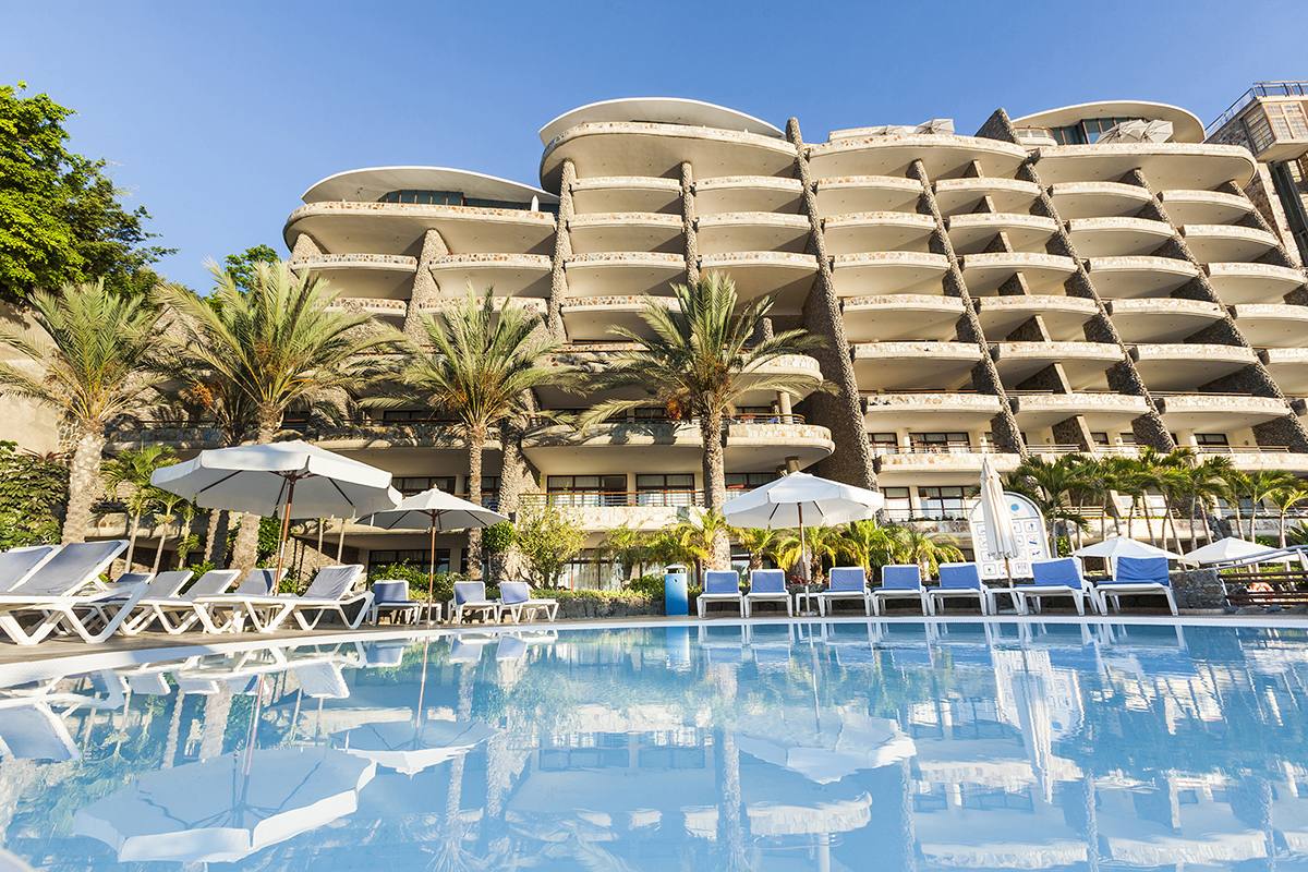 Monte Anfi resort pool with palm trees on Gran Canaria — buy, sell, and rent timeshares on BidMyTimeshare.com