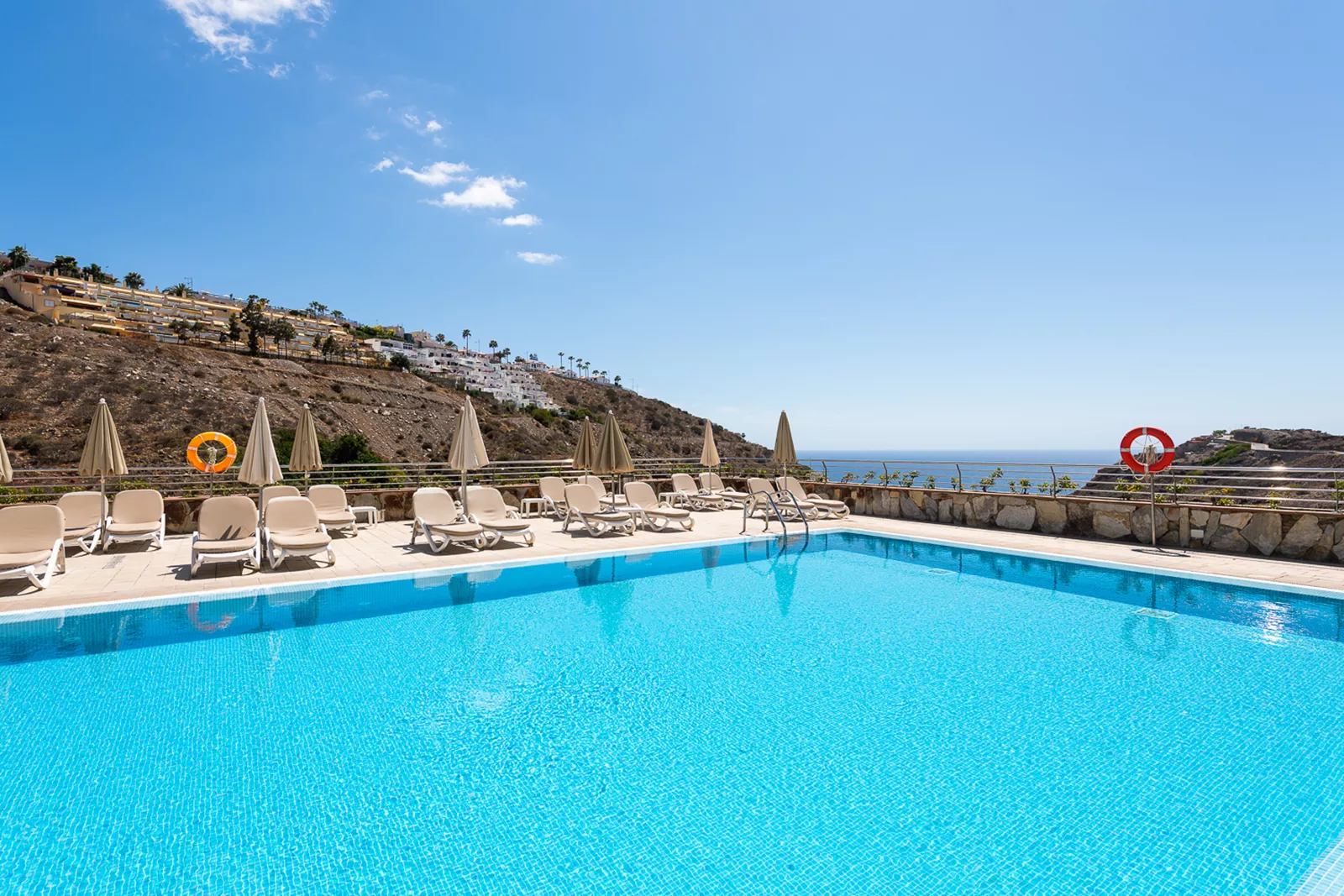 Sol Amadores resort pool overlooking the ocean on Gran Canaria — list and sell timeshare ownership on BidMyTimeshare.com